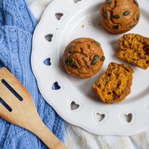 white plate with 3 pumpkin muffins on it