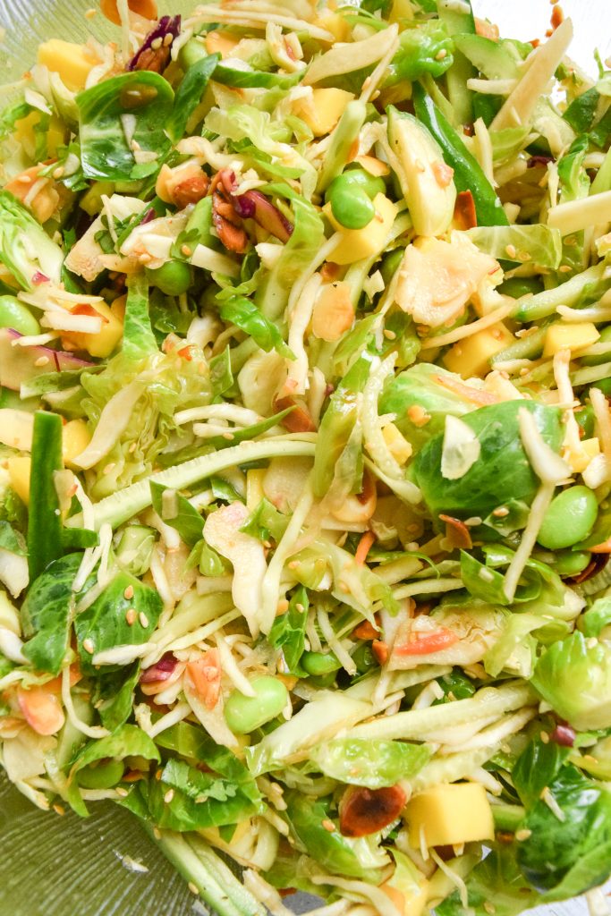 close up shot of brussels sprout slaw with edamame, toasted nuts