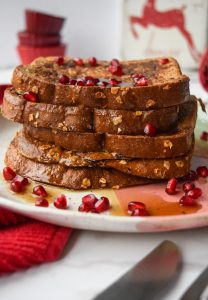 5 pieces of french toast topped with pomegranate