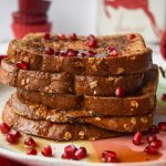 5 pieces of french toast topped with pomegranate