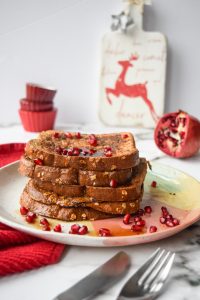 5 pieces of french toast topped with pomegranate