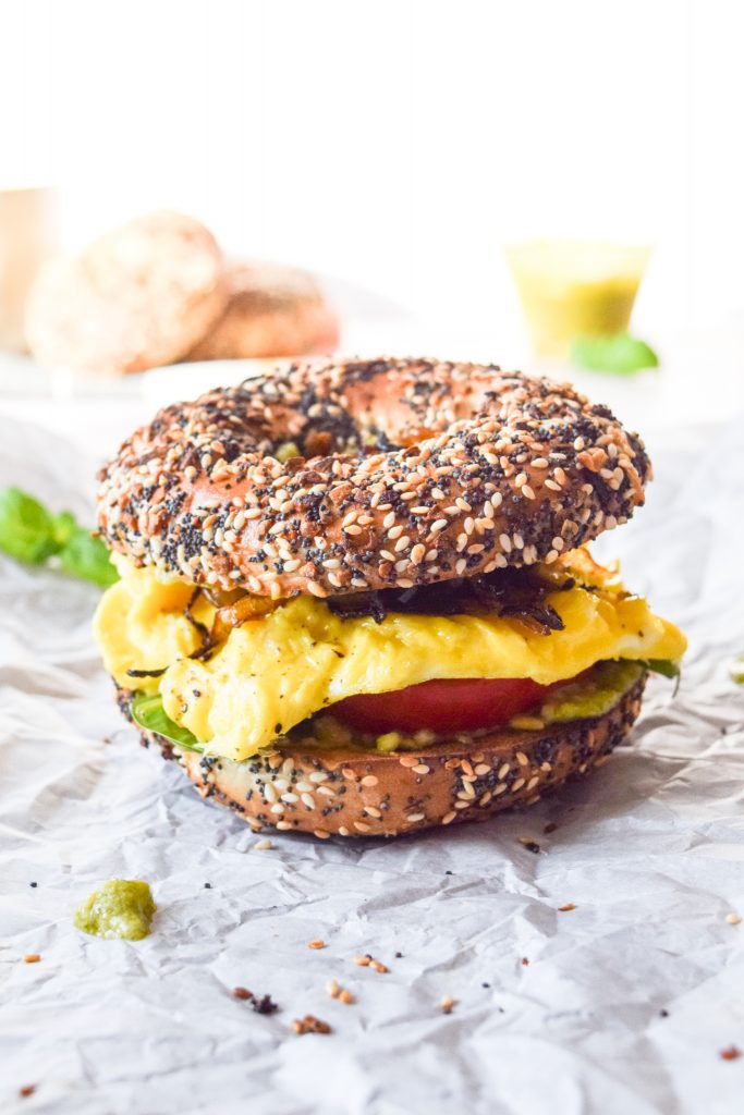 close up shot of a breakfast sandwich on an everything bagel