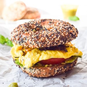 close up shot of a breakfast sandwich on an everything bagel