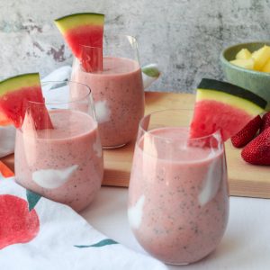 3 watermelon and fruit smoothies topped with a slice of watermelon